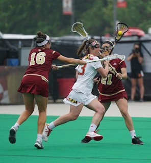 group of woman playing lacrosse
