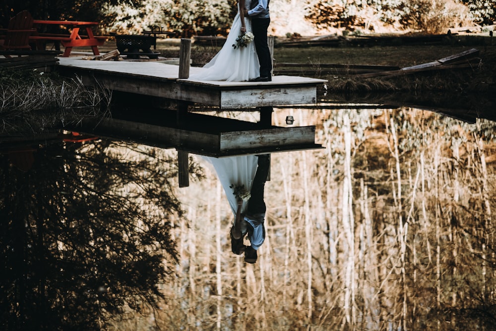 woman and man kissing on dock bay