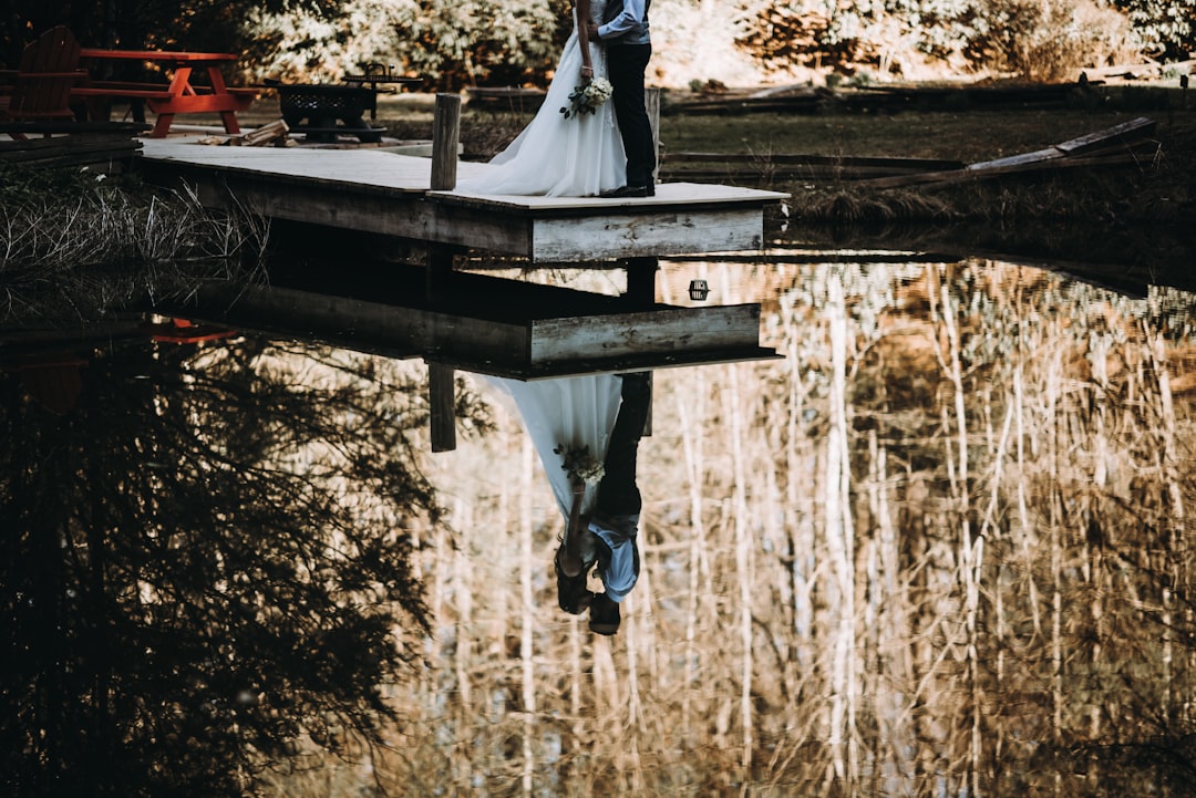 woman and man kissing on dock bay, A beautiful and intimate wedding shot in the Mountains of western North Carolina! We 