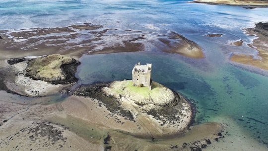 body of water under sunny sky in Castle Stalker United Kingdom