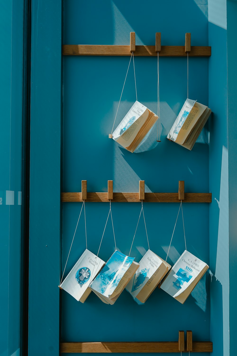 six hanging books on wall