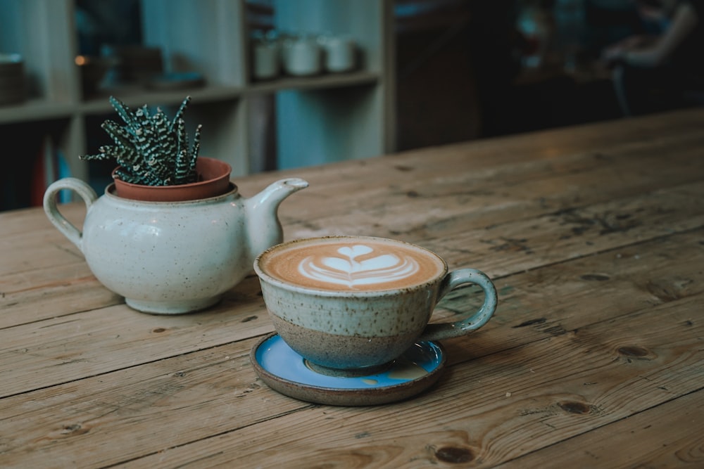 white and beige ceramic mug