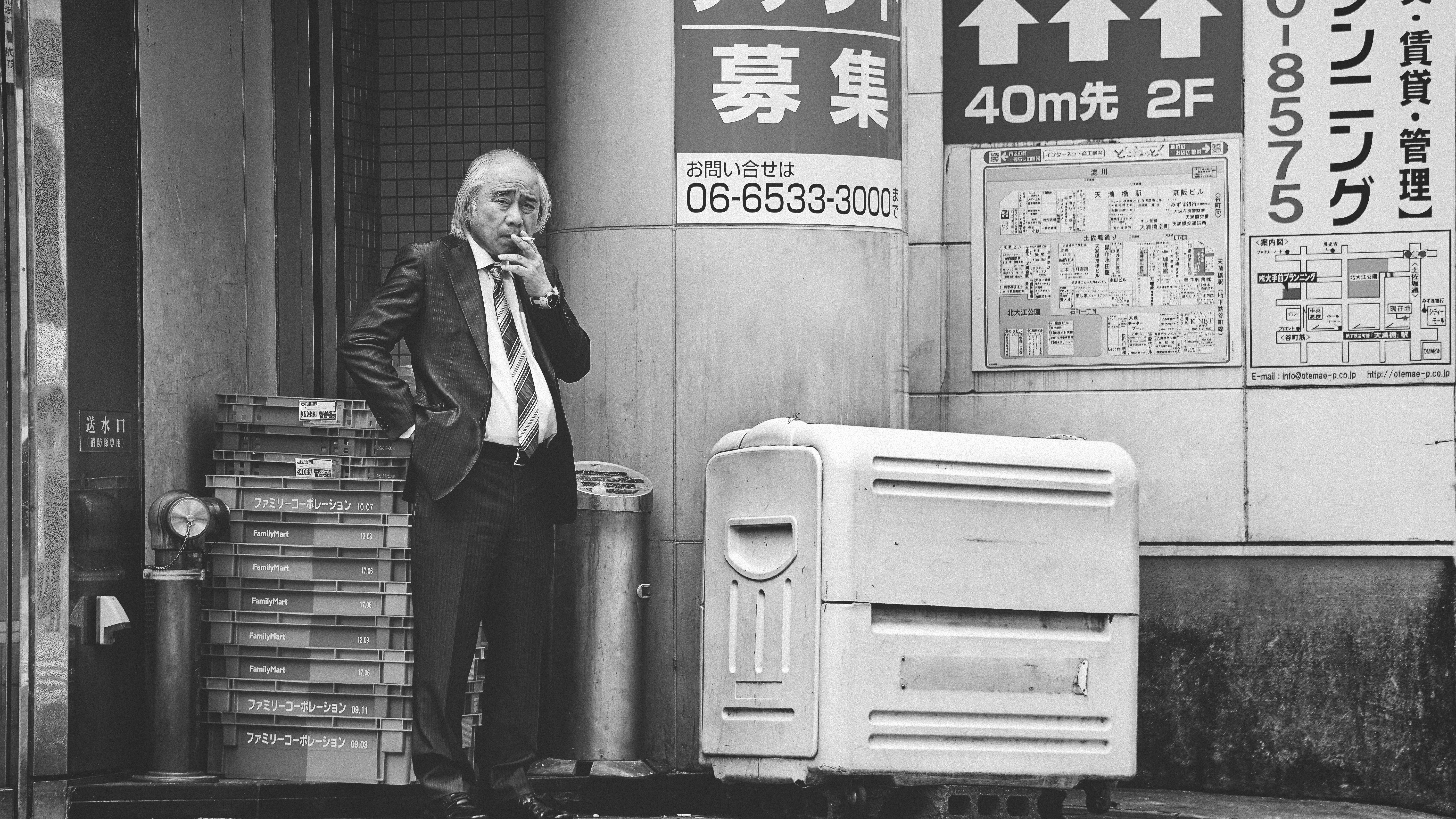 grayscale photo of man smoking cigarette, I believe the expression on this man’s face, his gaze and posture all make the photo worthwhile.
