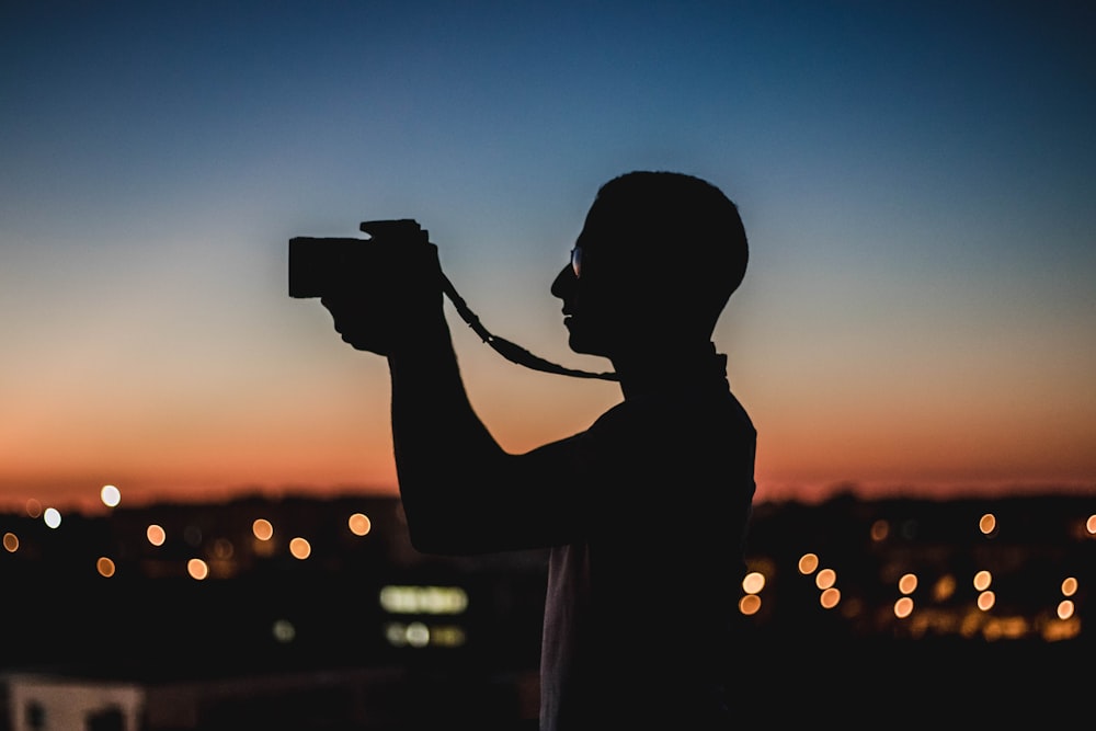 man holding DSLR camera