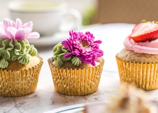 three cupcakes on table