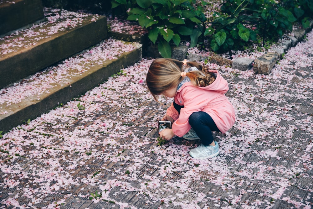 little girl looking at flowers