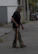 Happy elderly man walking outdoors with ease after treatment.