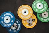 three pairs of assorted-color Rogue bumper plates