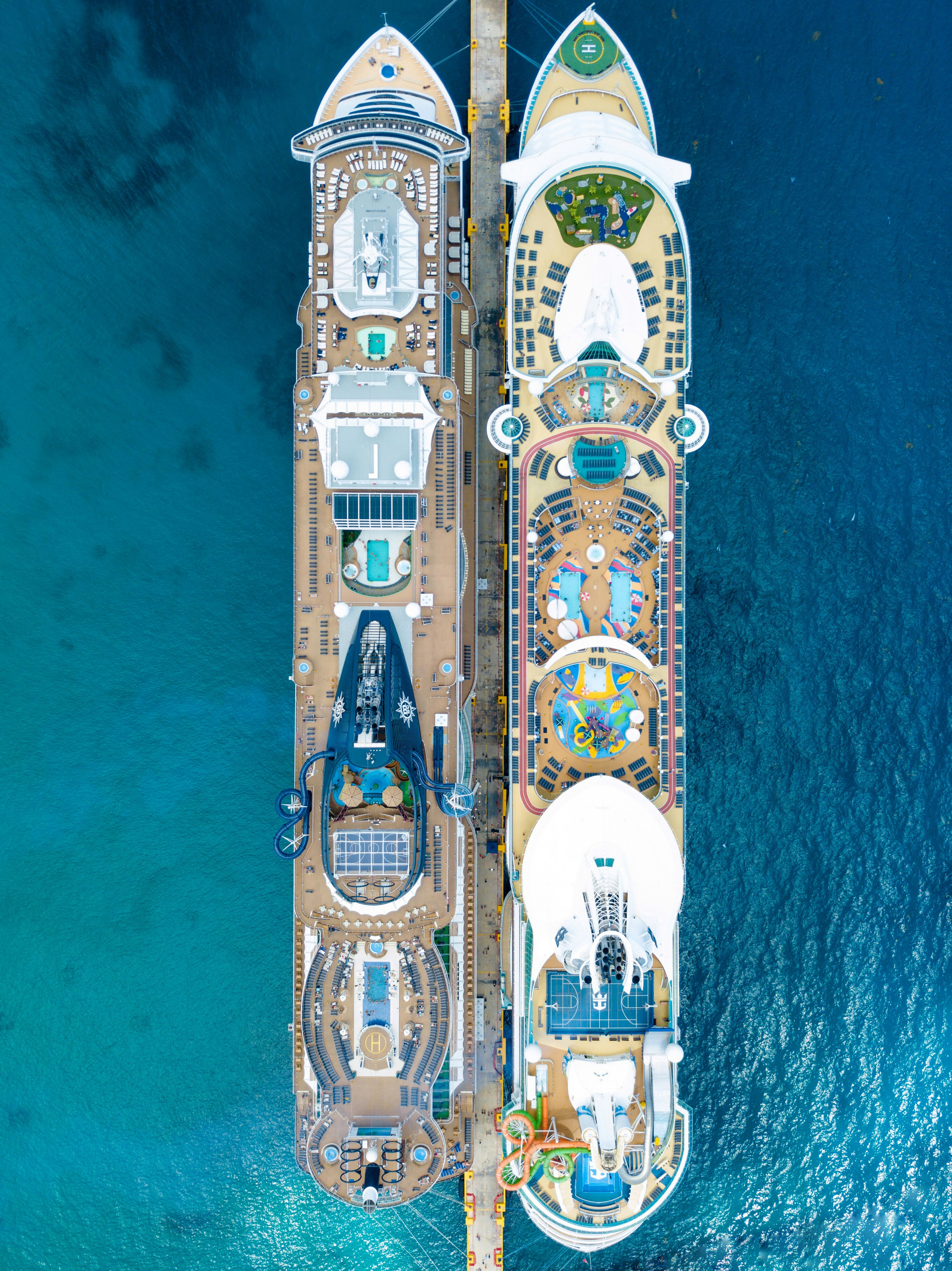 This photo was taken at the cruise port in Costa Maya, Mexico. The ship on the right is the Royal Caribbean Liberty of the Seas and the ship on the right is the MSC seaside. It is very cool to see the differences in the ships from above. Which ship would you prefer to be on?