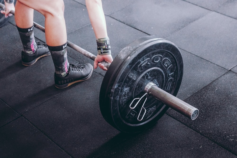 person holding barbell