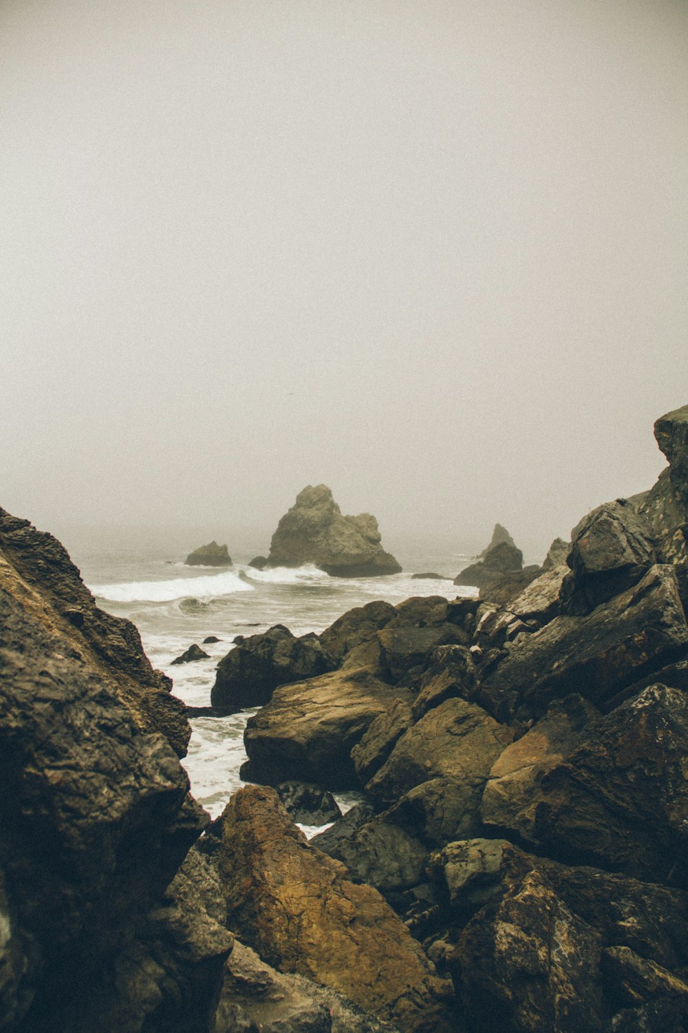 brown rock formation under cloudy sky