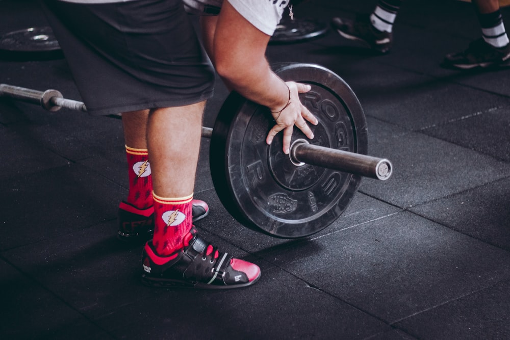 person arranging barbell plate