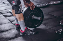person holding black barbell plate
