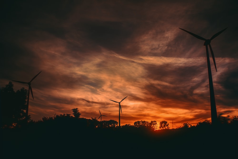 Silhouette von Windmühlen bei Sonnenuntergang