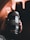 Close-up of hands holding a camera lens with blurred studio lights in the background.