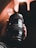 Close-up of hands holding a camera lens with blurred studio lights in the background.