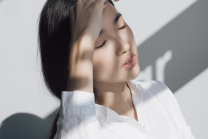 woman leaning on white table