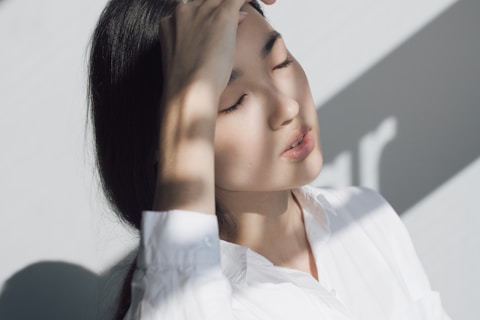 woman leaning on white table