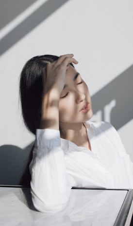 woman leaning on white table