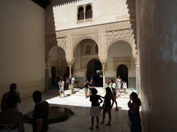 Soft morning light filtering through arches of a serene Islamic architectural courtyard.