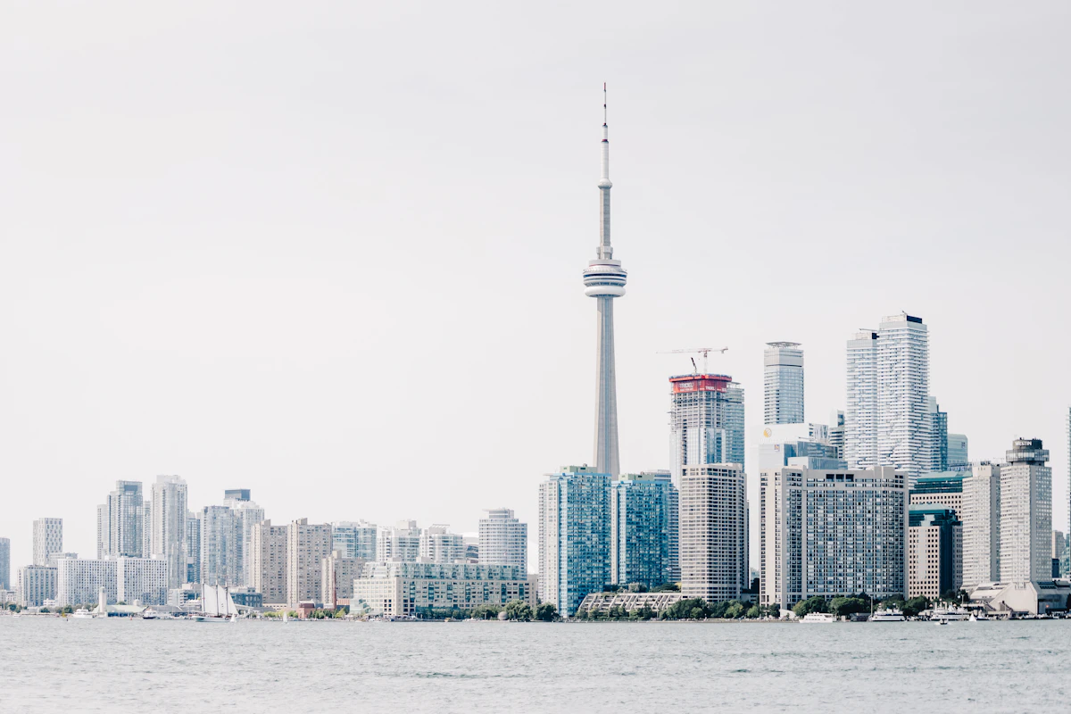The CN Tower above downtown Toronto under a bright sky
