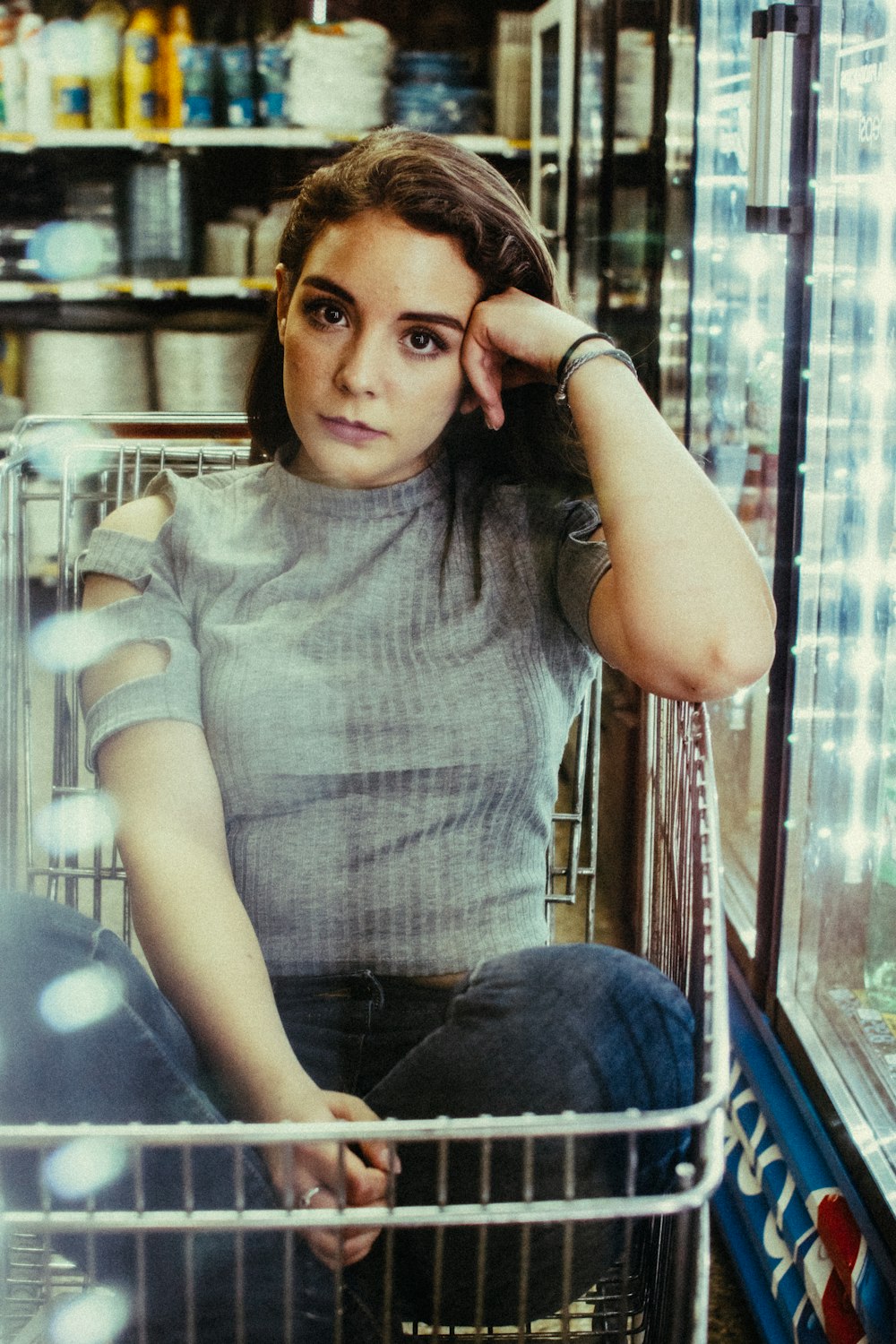 woman sitting inside shopping cart