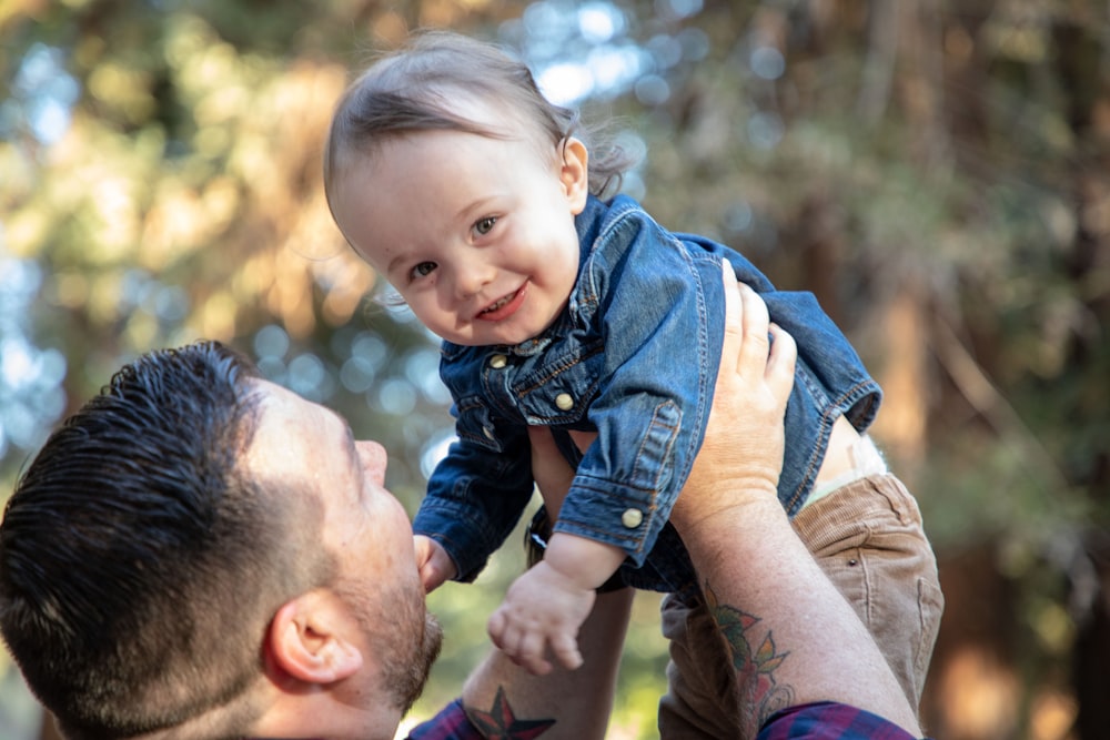 man carrying baby