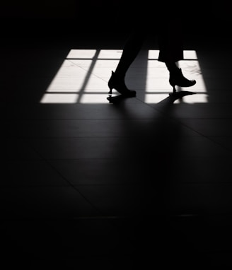 silhouette of person wearing heeled booties