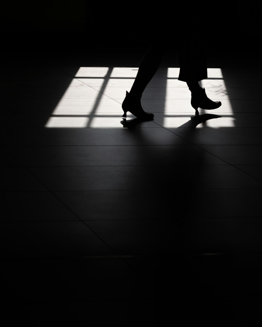 silhouette of person wearing heeled booties