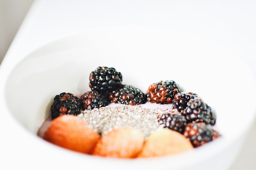 raspberry and blackberry on white bowl