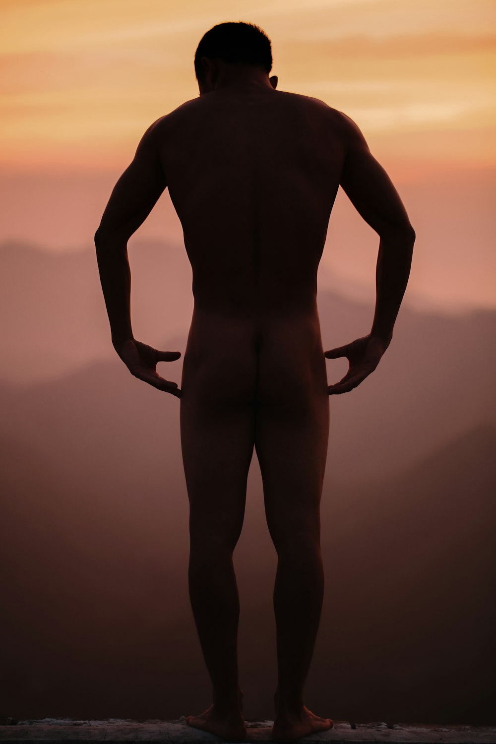 naked man standing on edge