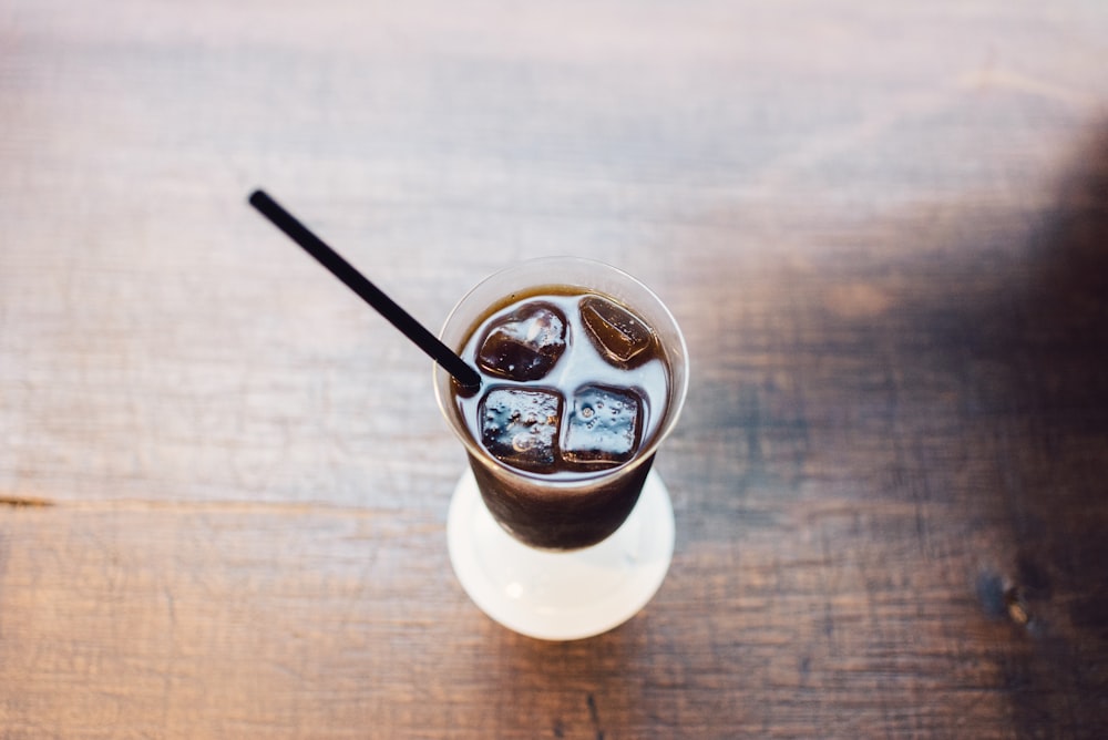 soda drink with ice cube and straw