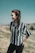 woman standing on green grass while hands in black pocket