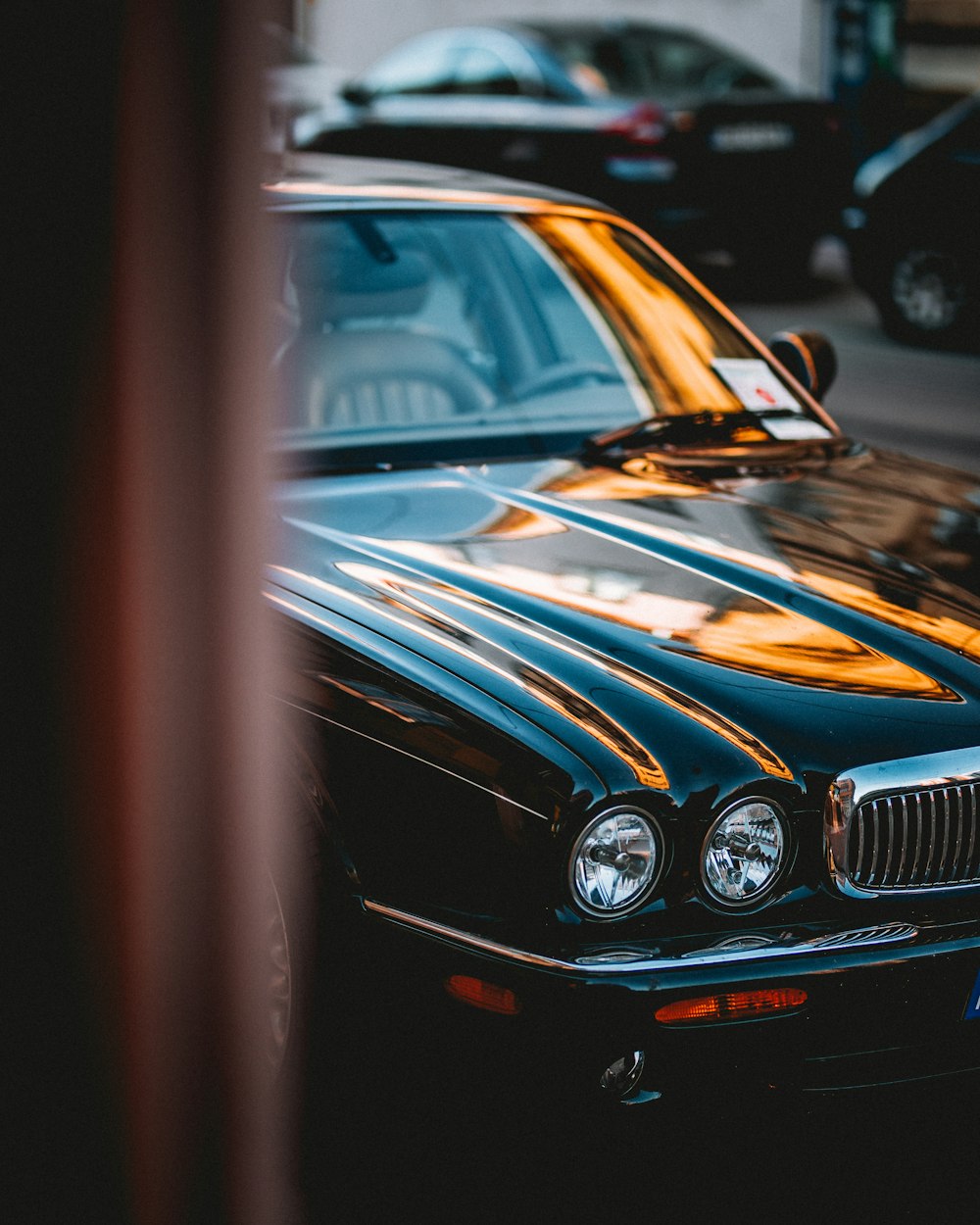 photo of black Jaguar X-type parked near black vehicles