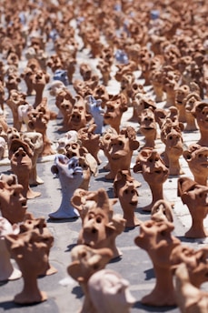 clay head art pieces of various sizes, shapes, and colours