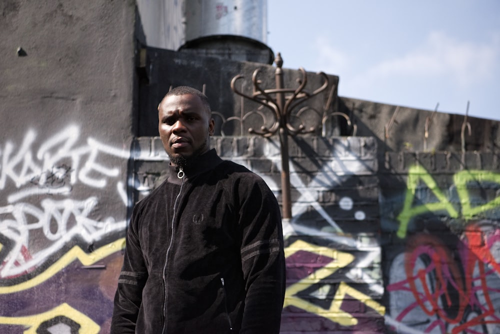 man near wall with graffiti