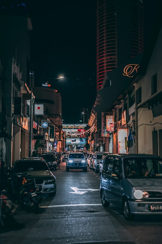 grey vehicle parked near white concrete building in George Town Malaysia