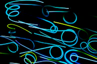 A stylized black backdrop with glowing electric blue sound waves pulsating outward.