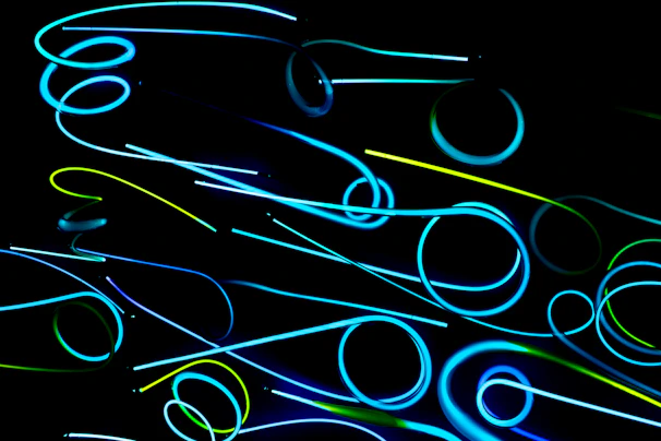 Abstract digital network lines glowing softly against a black backdrop.