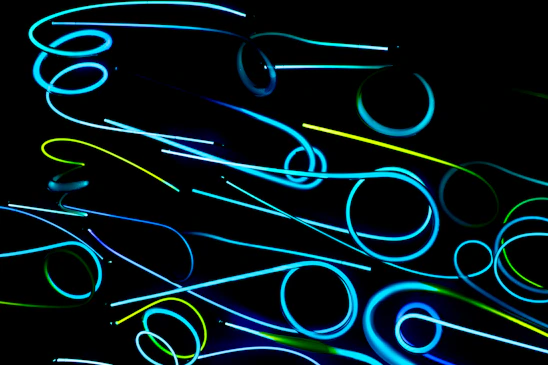 A glowing neural network pattern intertwined with geometric shapes, set against a deep electric blue and neon teal gradient background.