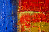 Close-up of a vibrant, textured acrylic painting with bold strokes.