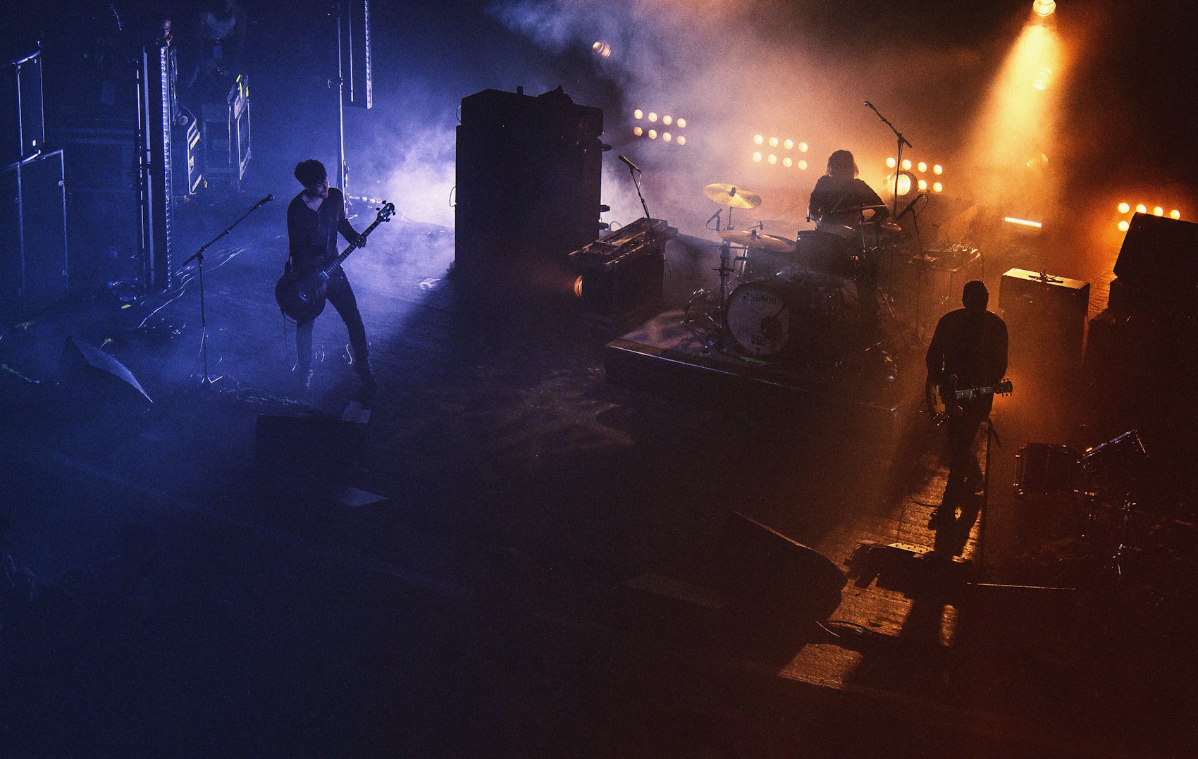 dark stage with neon lights and smoke