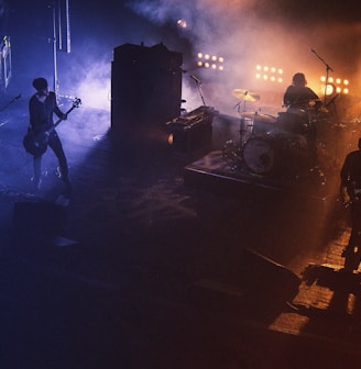 three people playing assorted instruments on stage