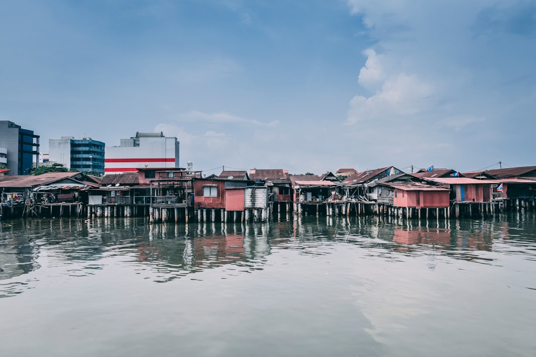 brown and pink houses surrounded by water at daytime