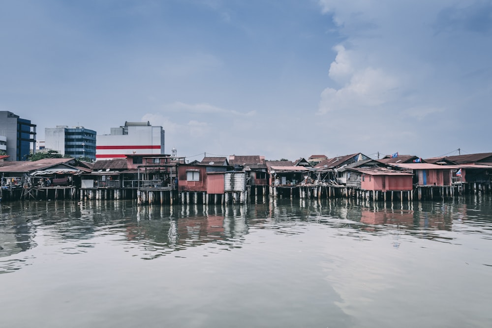 brown and pink houses surrounded by water at daytime