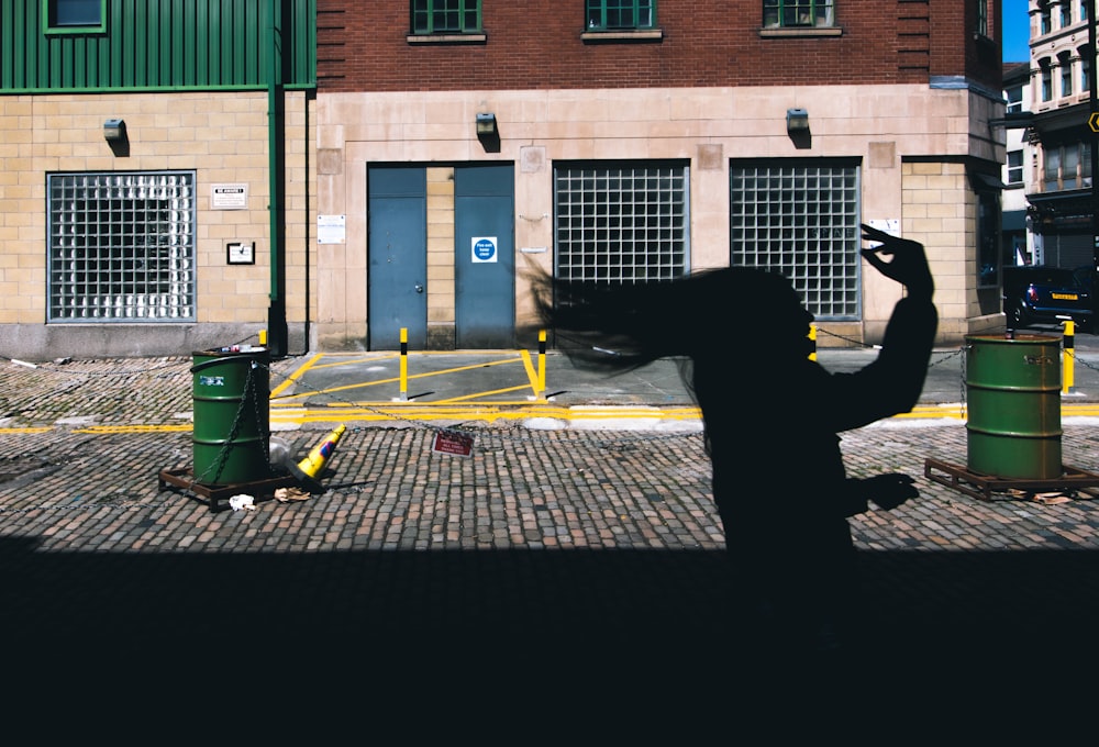 silhouette of woman running on road