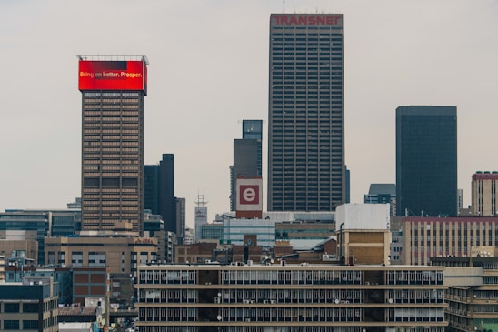 A collage showing Johannesburg cityscape, mining equipment, and a digital network overlay symbolizing IT connections.