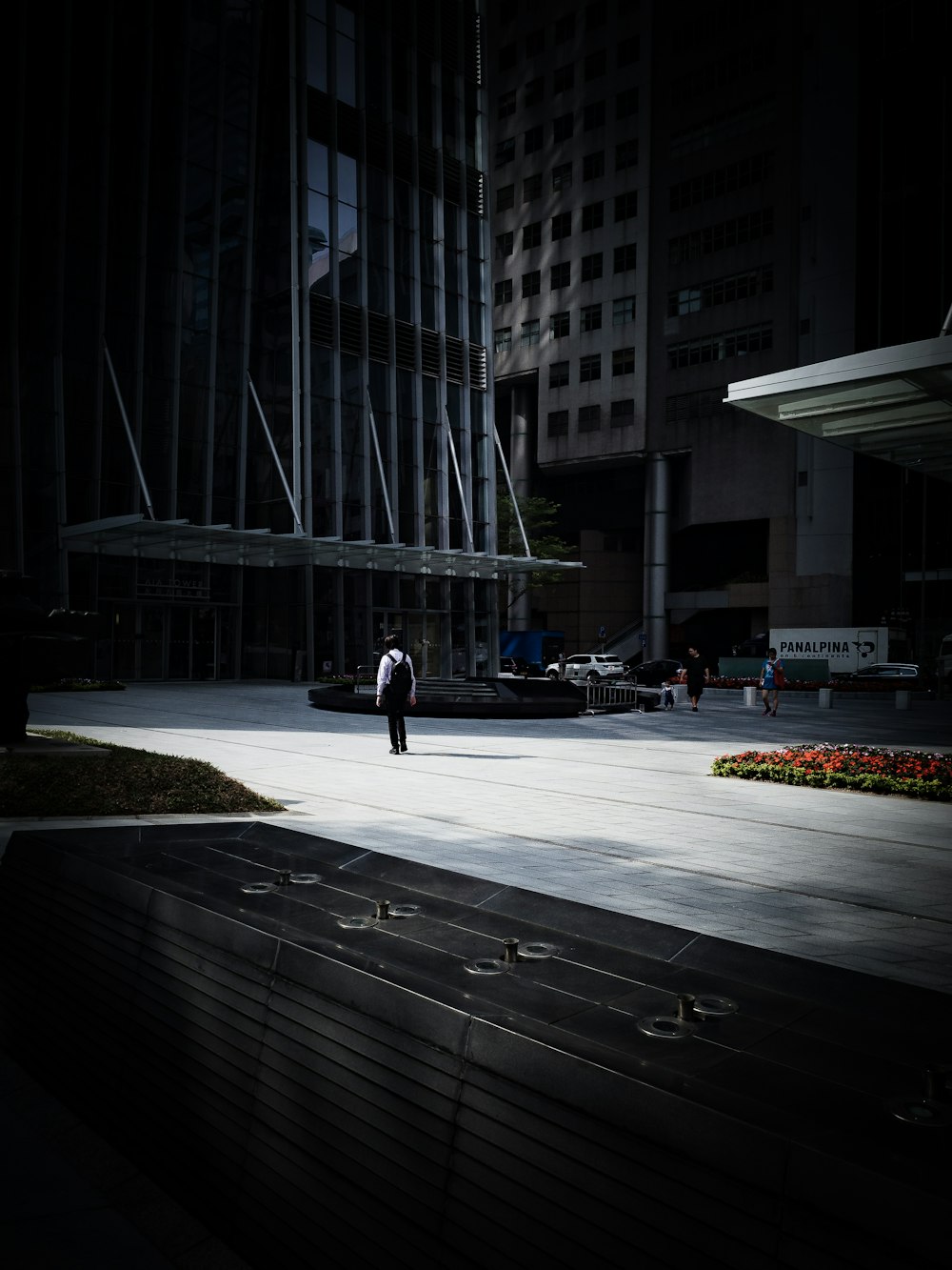 man standing in front of high-rise building