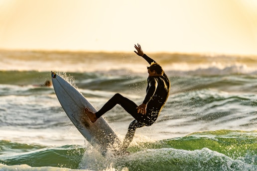 shallow focus photography of man surfing