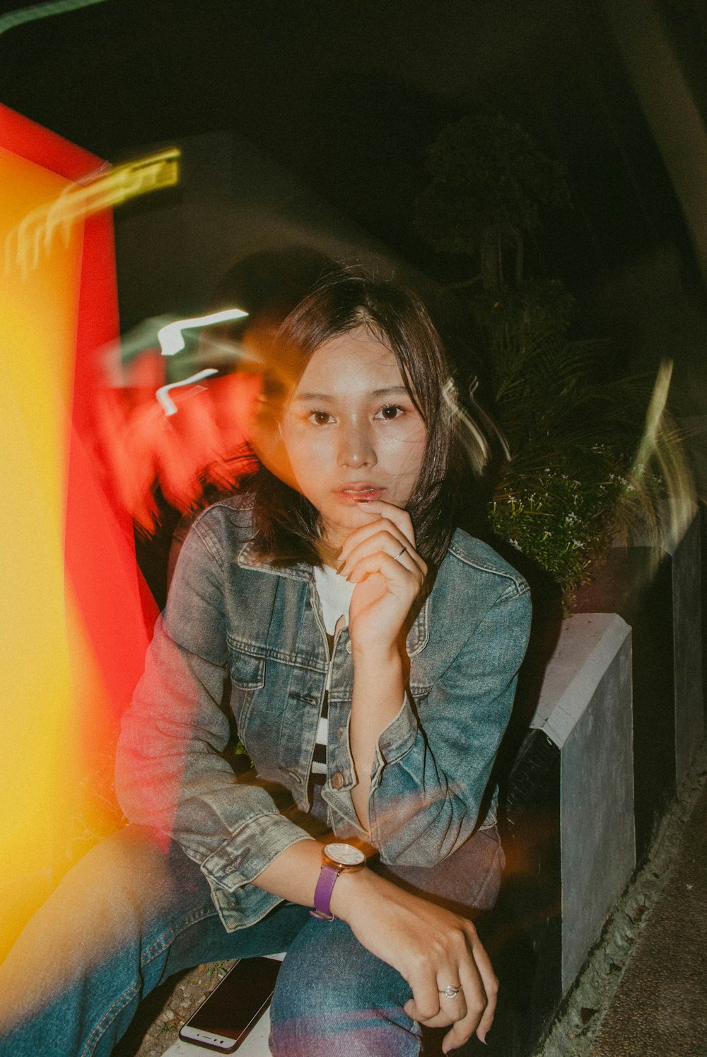 woman wearing blue denim jacket while taking selfie